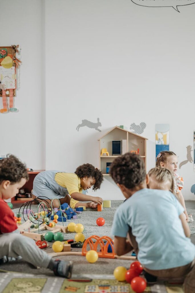 A lively group of children playing inside a colorful kindergarten classroom.